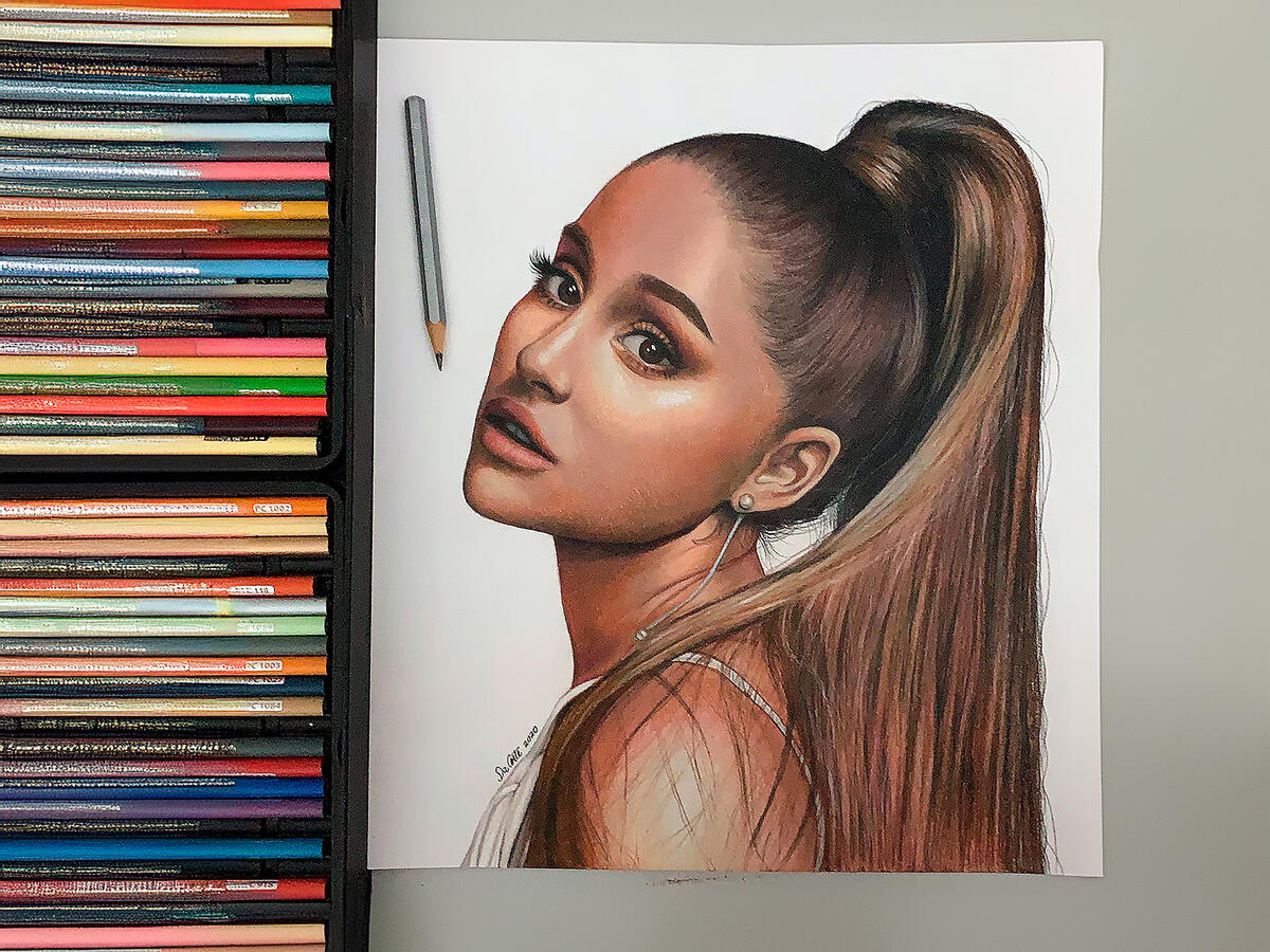 Realistic colored pencil portrait of Ariana Grande drawn by Juan Da Corte